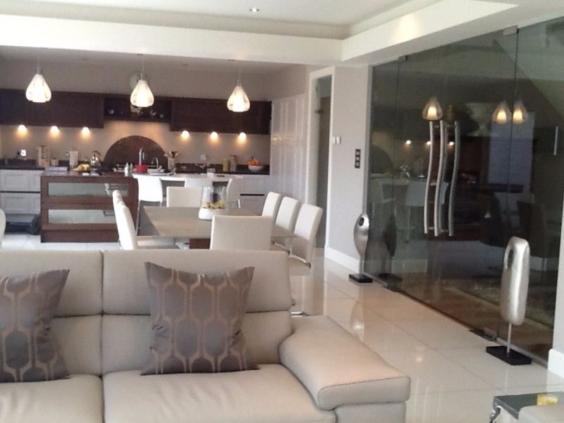 Open-plan living and dining space with glass partition
